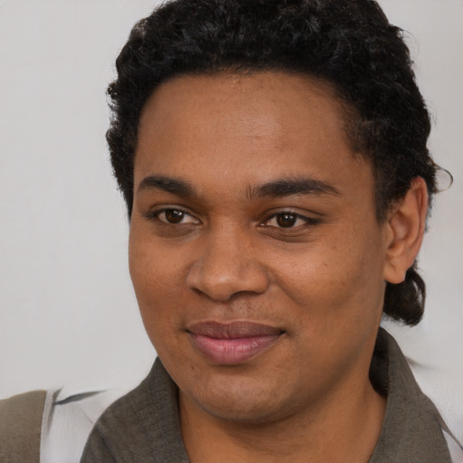 Joyful black young-adult male with short  black hair and brown eyes