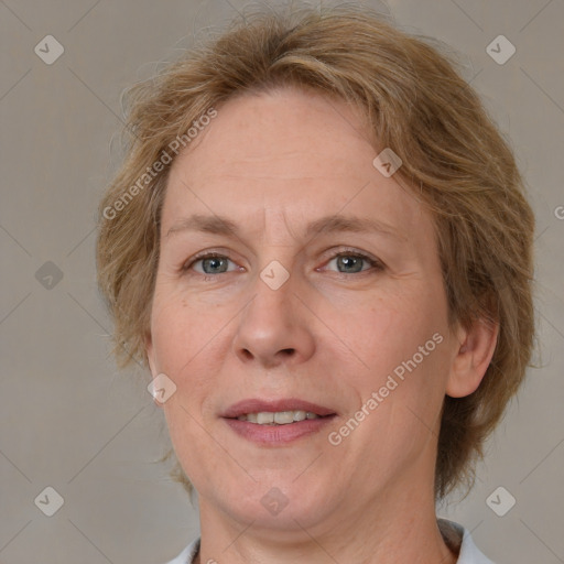 Joyful white adult female with medium  brown hair and blue eyes