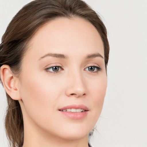 Joyful white young-adult female with long  brown hair and blue eyes