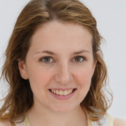 Joyful white young-adult female with medium  brown hair and blue eyes