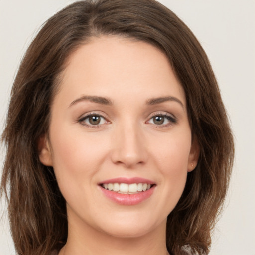 Joyful white young-adult female with long  brown hair and green eyes