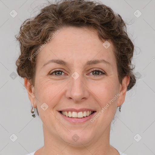 Joyful white adult female with short  brown hair and grey eyes