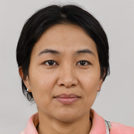 Joyful asian adult female with medium  brown hair and brown eyes
