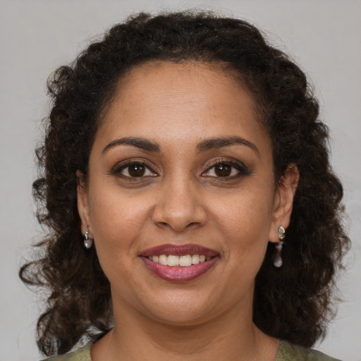 Joyful black young-adult female with medium  brown hair and brown eyes