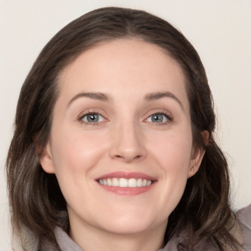 Joyful white young-adult female with medium  brown hair and grey eyes