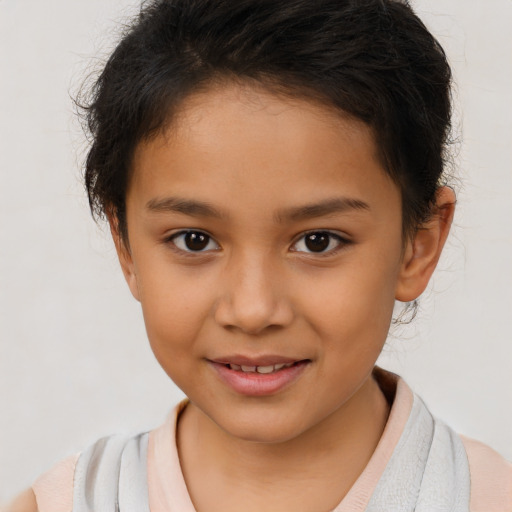 Joyful latino child female with short  brown hair and brown eyes