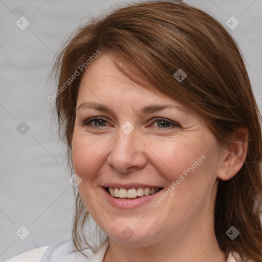 Joyful white adult female with medium  brown hair and grey eyes