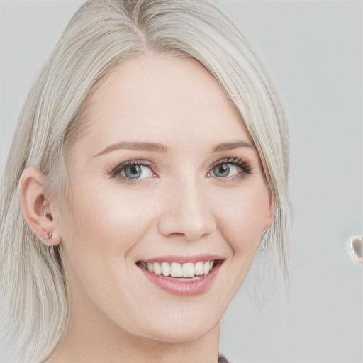 Joyful white young-adult female with medium  blond hair and blue eyes