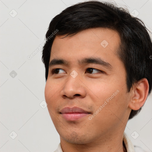 Joyful asian young-adult male with short  black hair and brown eyes