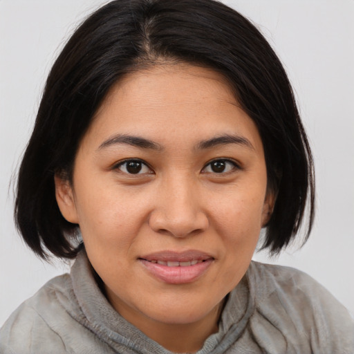 Joyful asian young-adult female with medium  brown hair and brown eyes