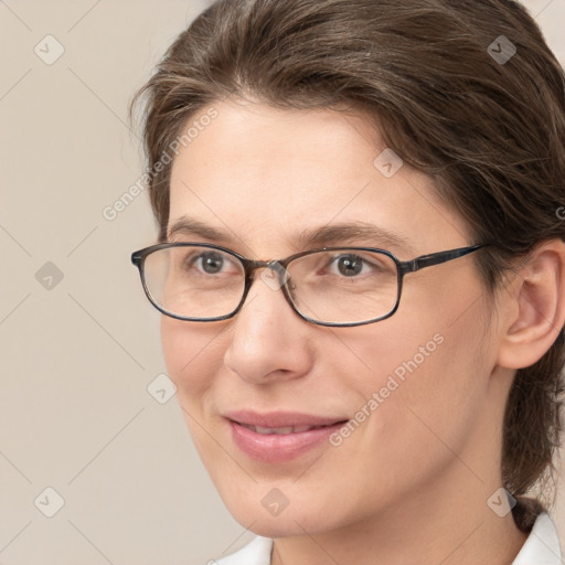 Joyful white adult female with medium  brown hair and grey eyes