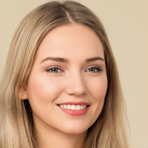 Joyful white young-adult female with long  brown hair and brown eyes