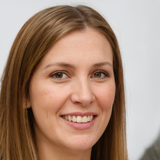 Joyful white young-adult female with long  brown hair and green eyes