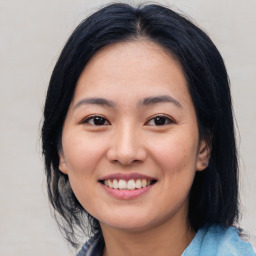 Joyful asian young-adult female with medium  black hair and brown eyes