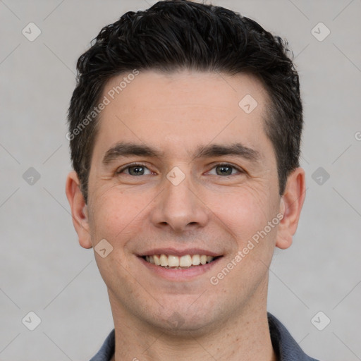 Joyful white young-adult male with short  black hair and brown eyes