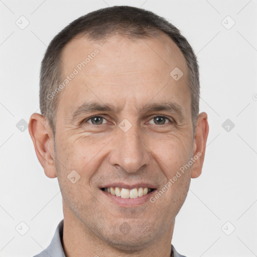 Joyful white adult male with short  brown hair and brown eyes