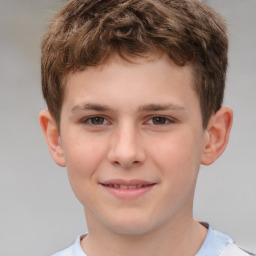 Joyful white child male with short  brown hair and brown eyes