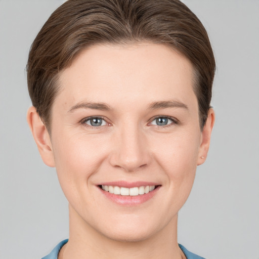 Joyful white young-adult female with short  brown hair and grey eyes