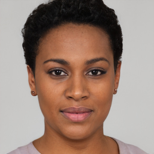 Joyful black young-adult female with short  black hair and brown eyes