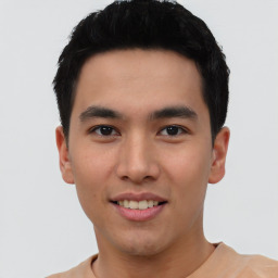 Joyful asian young-adult male with short  black hair and brown eyes