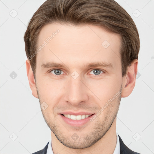 Joyful white young-adult male with short  brown hair and grey eyes