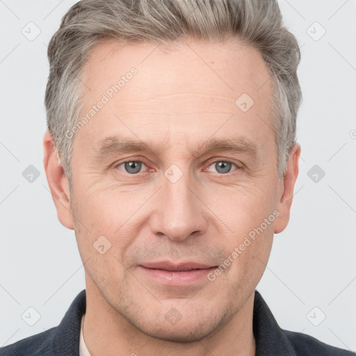 Joyful white adult male with short  brown hair and grey eyes