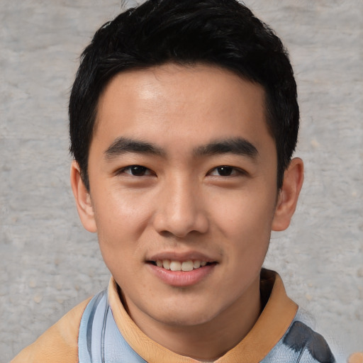 Joyful asian young-adult male with short  black hair and brown eyes