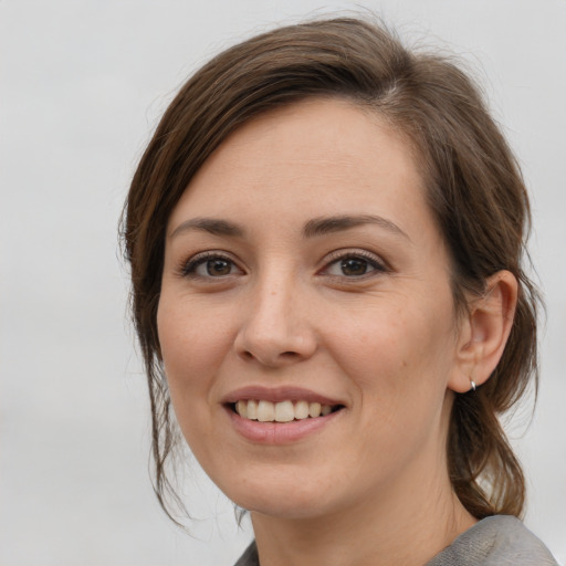 Joyful white young-adult female with medium  brown hair and brown eyes