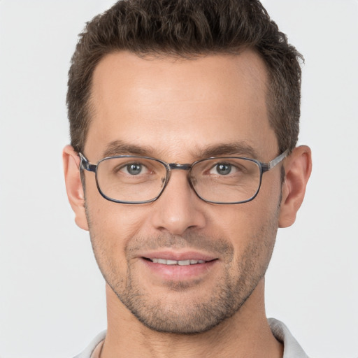 Joyful white adult male with short  brown hair and brown eyes