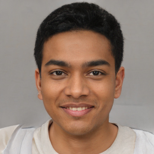 Joyful latino young-adult male with short  black hair and brown eyes