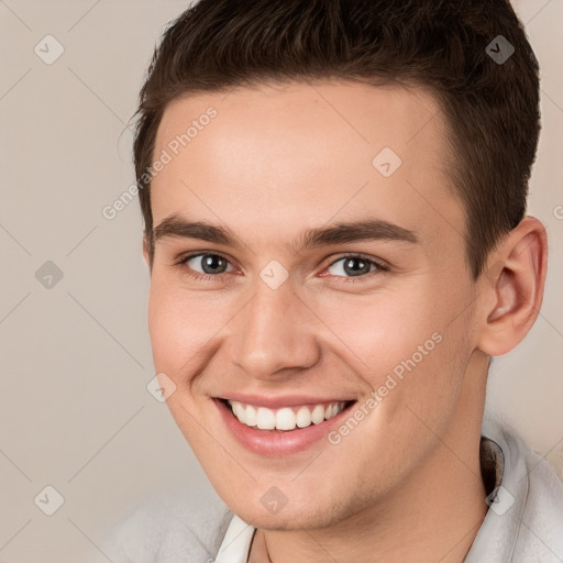 Joyful white young-adult male with short  brown hair and brown eyes