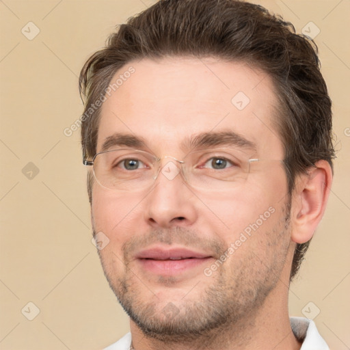 Joyful white adult male with short  brown hair and brown eyes