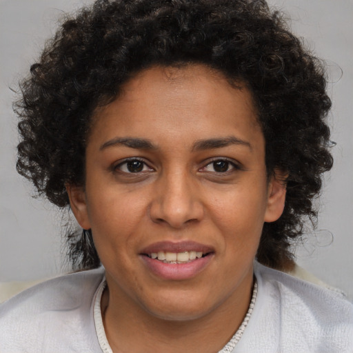 Joyful black young-adult female with short  brown hair and brown eyes