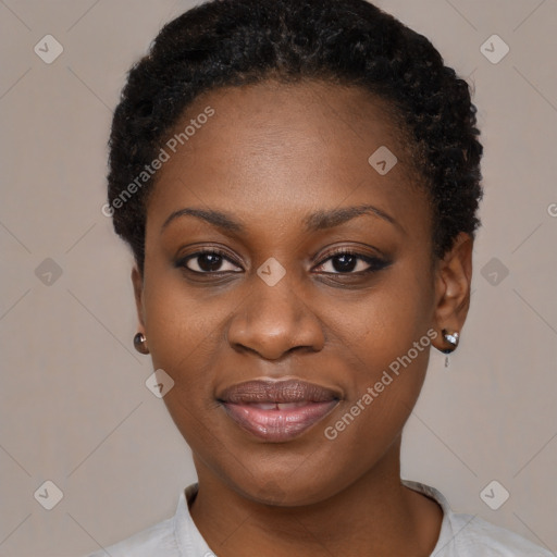 Joyful black young-adult female with short  black hair and brown eyes