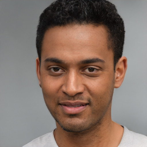 Joyful black young-adult male with short  black hair and brown eyes