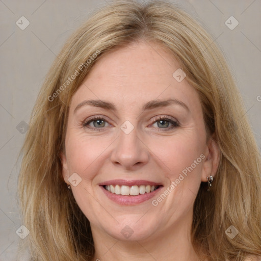 Joyful white adult female with long  brown hair and brown eyes