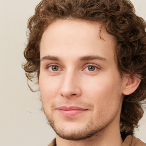 Joyful white young-adult male with short  brown hair and green eyes