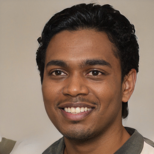 Joyful black young-adult male with short  black hair and brown eyes