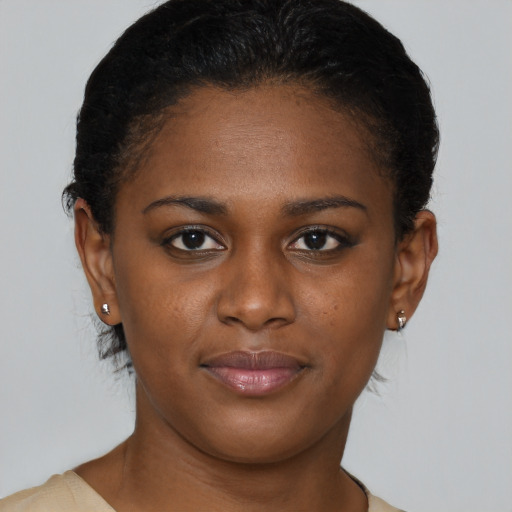 Joyful black young-adult female with short  brown hair and brown eyes