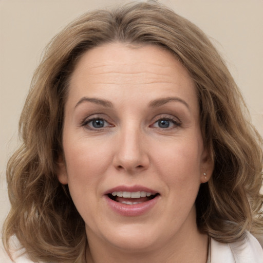 Joyful white adult female with medium  brown hair and grey eyes