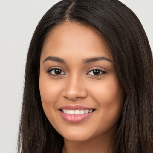 Joyful latino young-adult female with long  black hair and brown eyes