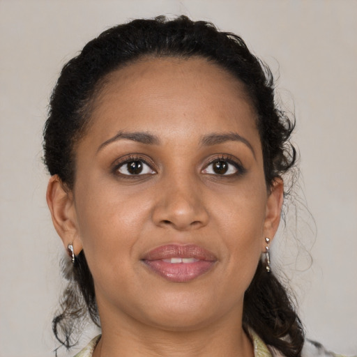 Joyful black adult female with medium  brown hair and brown eyes
