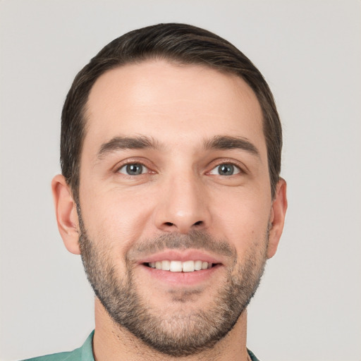 Joyful white young-adult male with short  brown hair and brown eyes