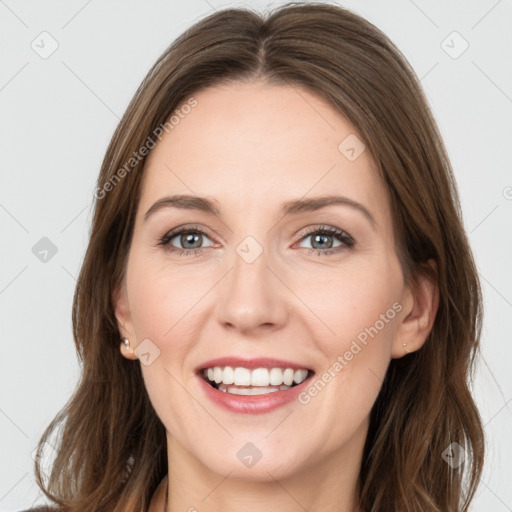 Joyful white young-adult female with long  brown hair and grey eyes