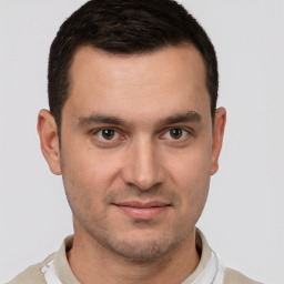 Joyful white young-adult male with short  brown hair and brown eyes