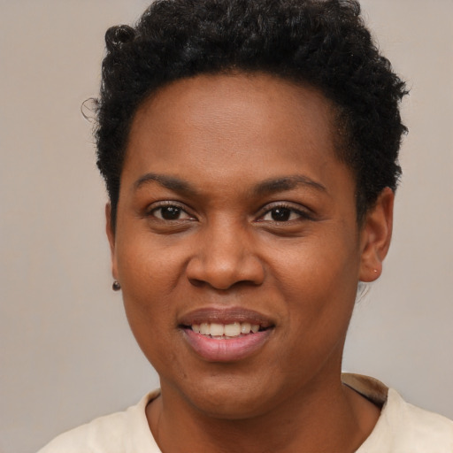 Joyful black young-adult female with short  brown hair and brown eyes