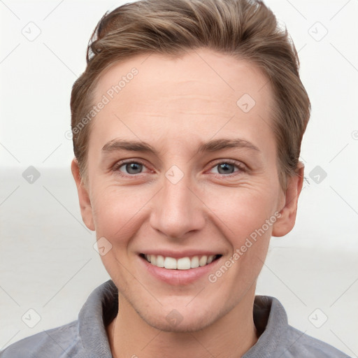 Joyful white young-adult female with short  brown hair and grey eyes