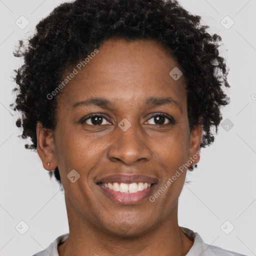 Joyful black adult female with short  brown hair and brown eyes