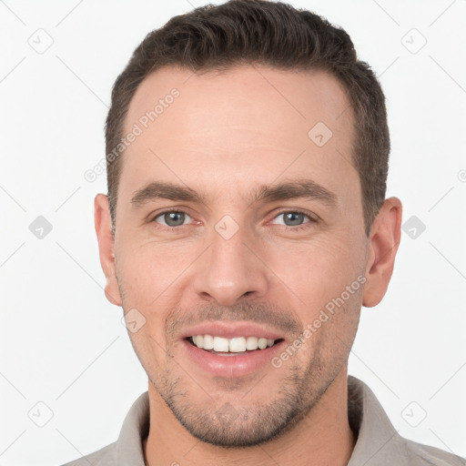 Joyful white young-adult male with short  brown hair and brown eyes