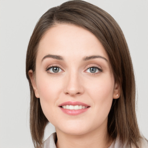 Joyful white young-adult female with medium  brown hair and grey eyes